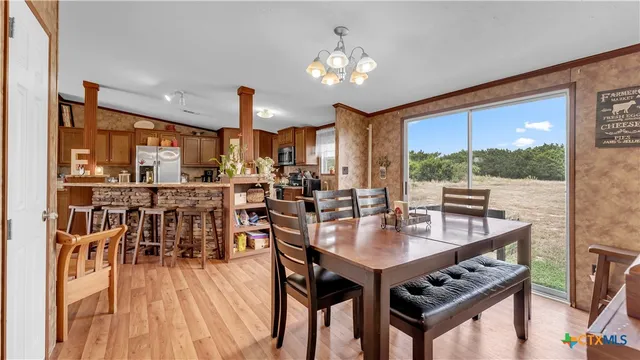 a kitchen with stainless steel appliances granite countertop a refrigerator a stove top oven a sink and dishwasher