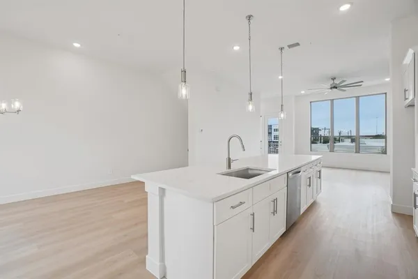 a bathroom with a shower sink vanity and toilet