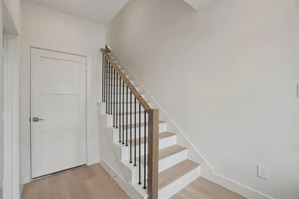 an empty room with fan and windows