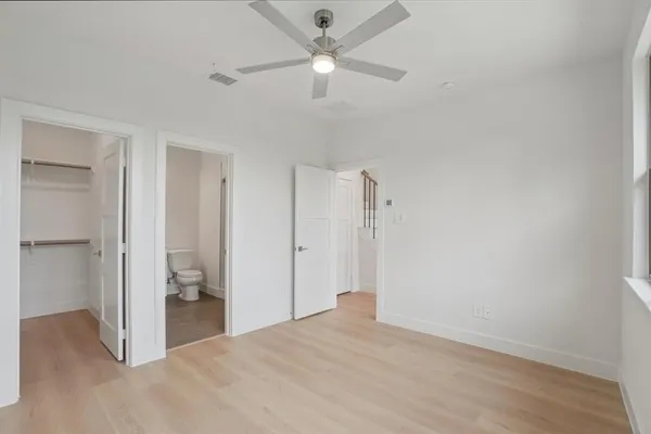 a view of staircase with railing and white walls