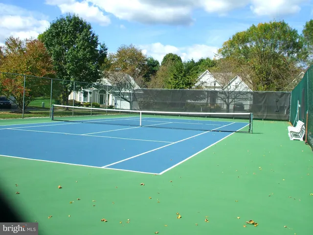 a view of a pathway in front of house with wooden fence
