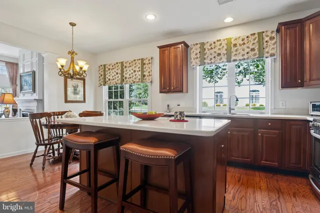 a kitchen with a table chairs sink and cabinets