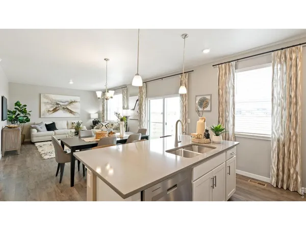 a kitchen with a dining table chairs and stove
