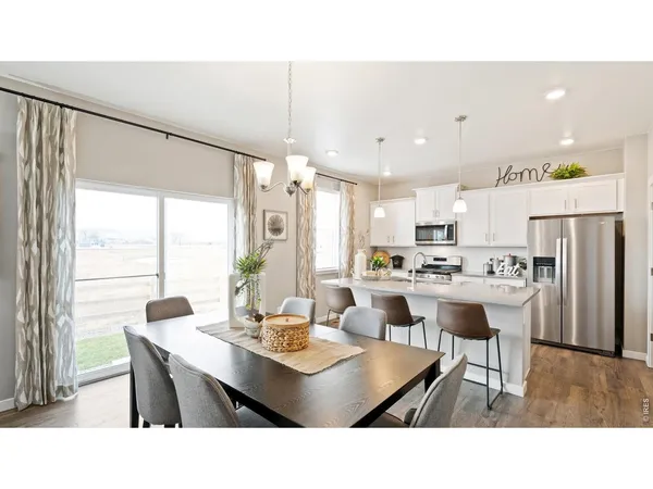 a living room with stainless steel appliances kitchen island granite countertop furniture and a dining table