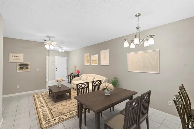a view of a dining room with furniture and chandelier