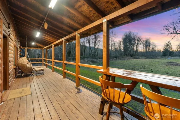 a backyard of a house with wooden fence and large trees