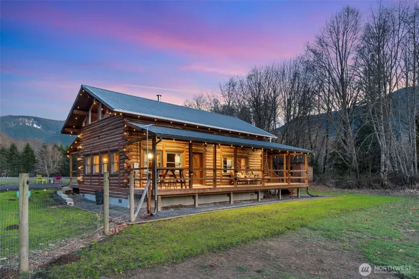 a view of a house with patio and a yard