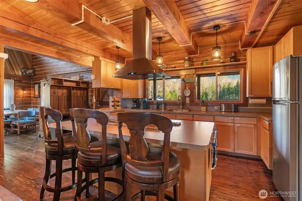 a kitchen with stainless steel appliances granite countertop a sink a stove and a refrigerator