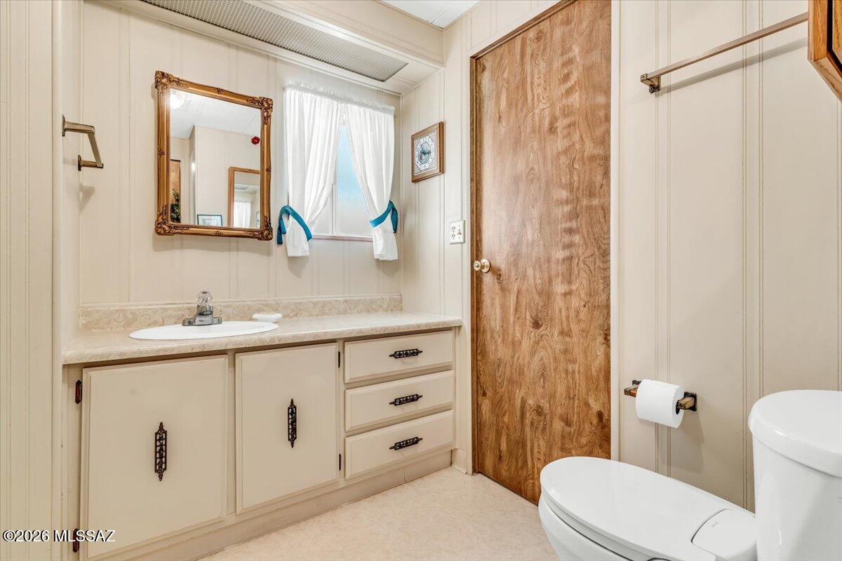 5840 West Flying W Street Tucson, AZ 85713 - Photo 26 of 38 a bathroom with a granite countertop sink toilet and shower
