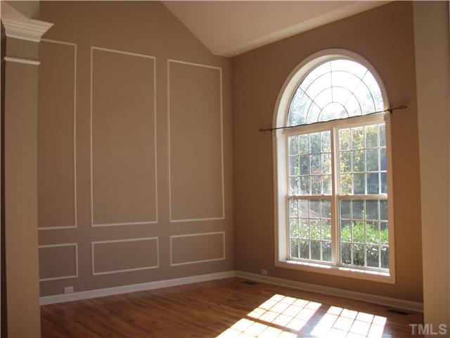 5029 Bartons Enclave Lane Raleigh, NC 27613 - Photo 2 of 25 an empty room with wooden floor and windows