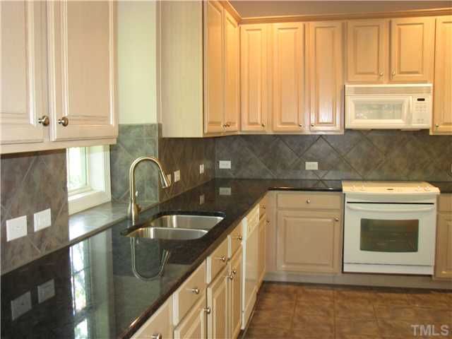 5029 Bartons Enclave Lane Raleigh, NC 27613 - Photo 4 of 25 a kitchen with stainless steel appliances granite countertop a sink a stove and cabinets