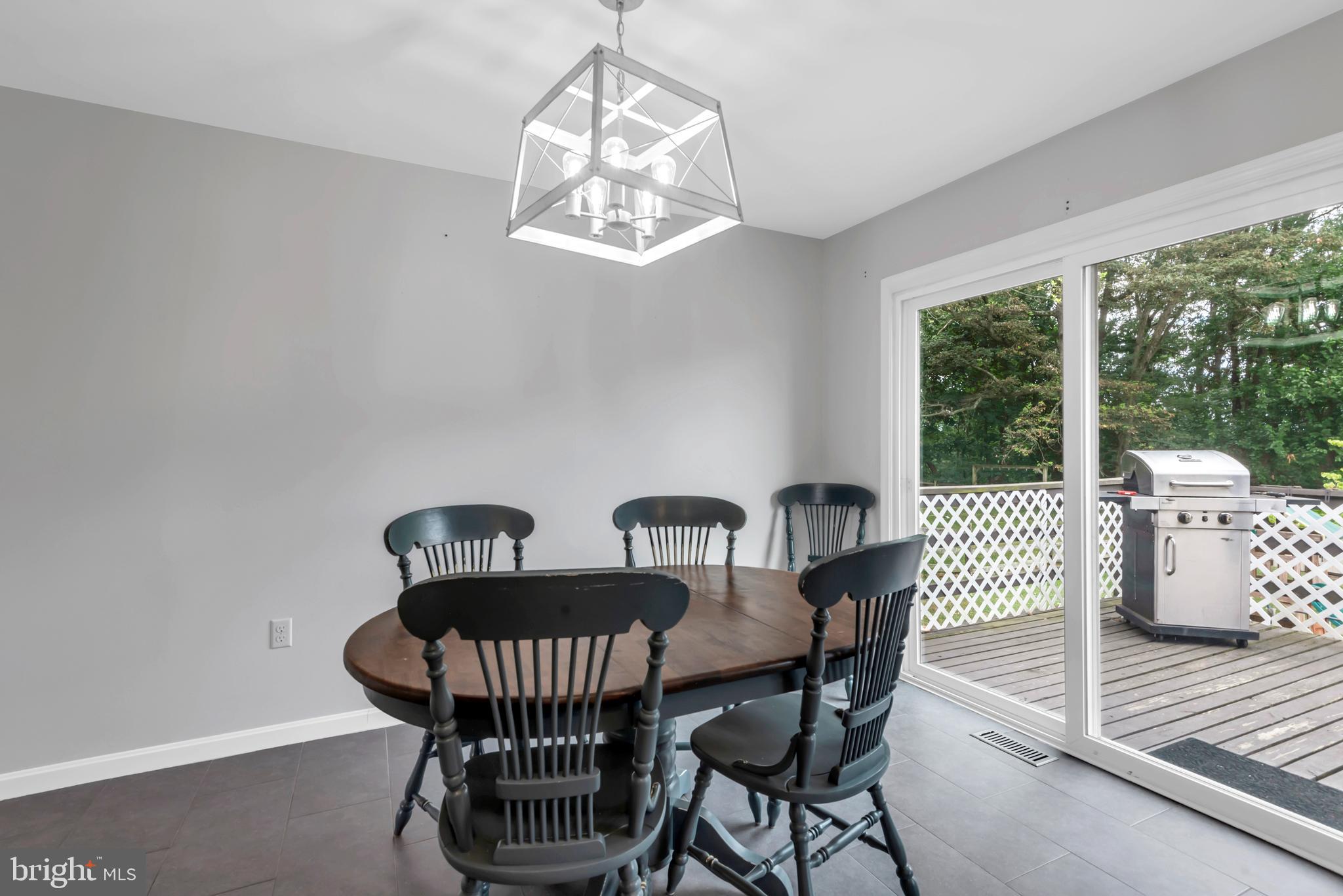 644 Jasontown Road Westminster, MD 21158 - Photo 15 of 36 a view of a dining room with furniture a chandelier and wooden floor