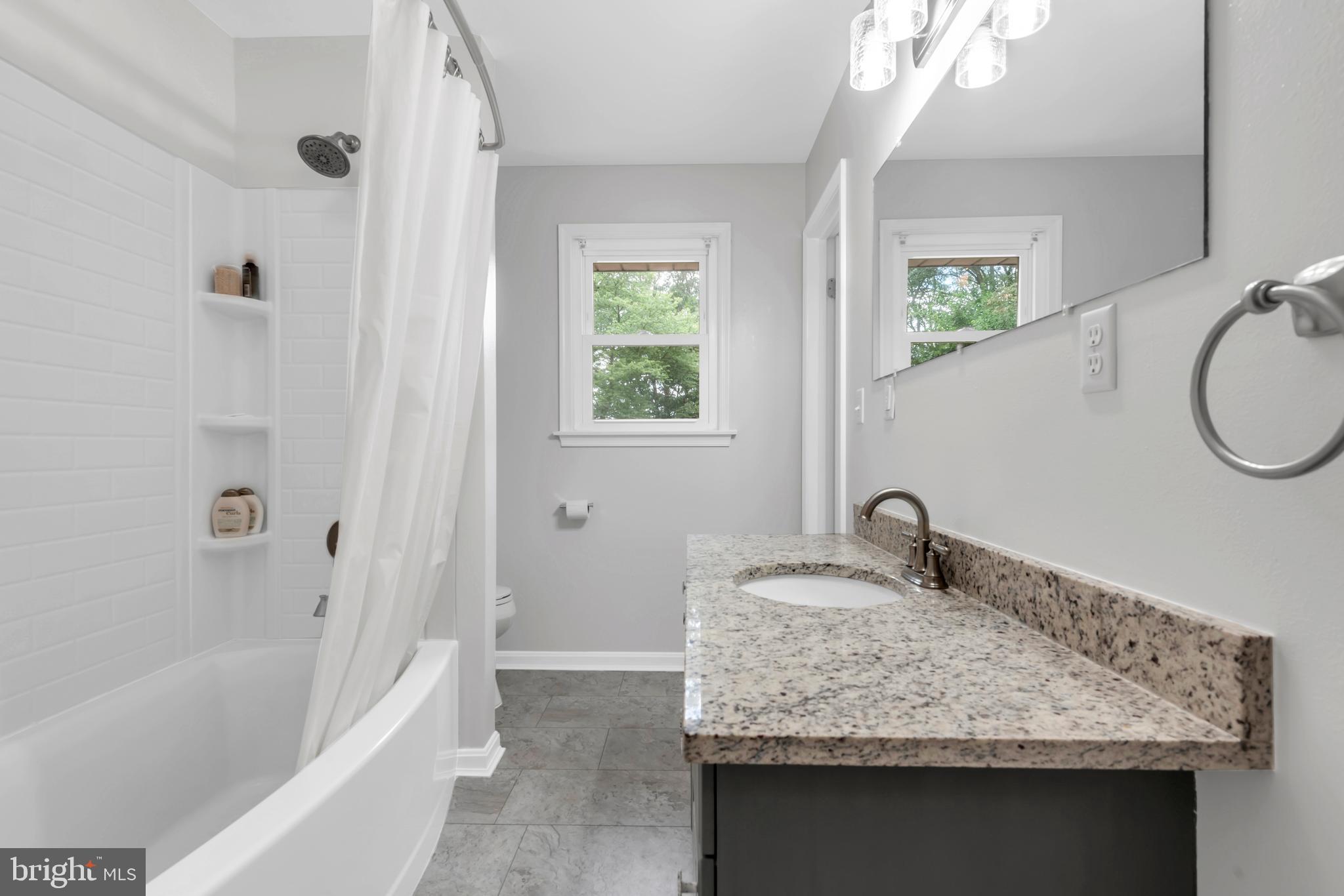 644 Jasontown Road Westminster, MD 21158 - Photo 19 of 36 a bathroom with a granite countertop sink and a mirror