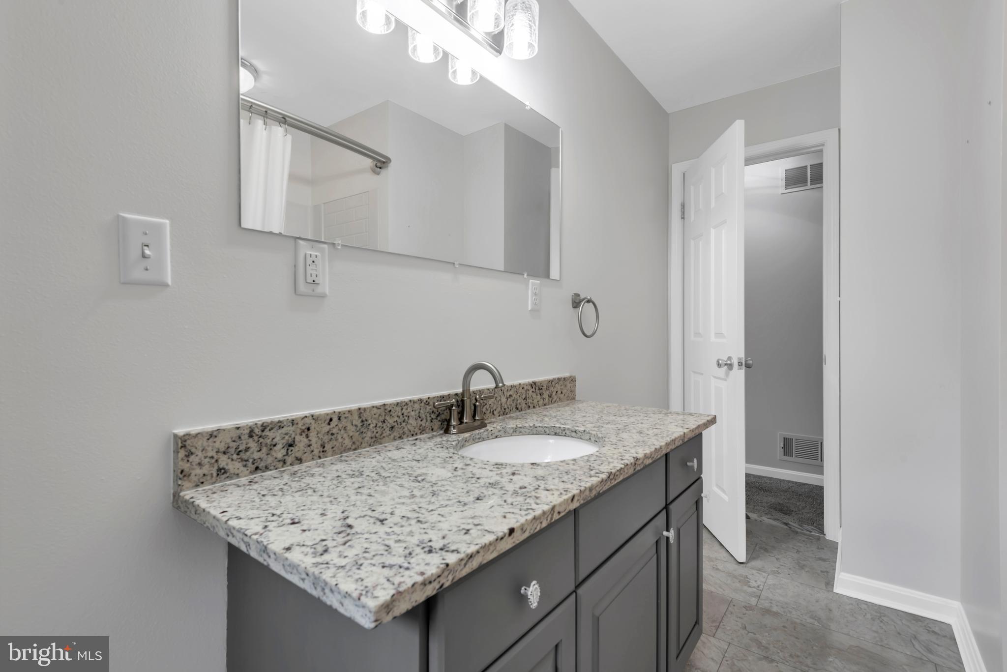 644 Jasontown Road Westminster, MD 21158 - Photo 20 of 36 a bathroom with a granite countertop sink and a mirror