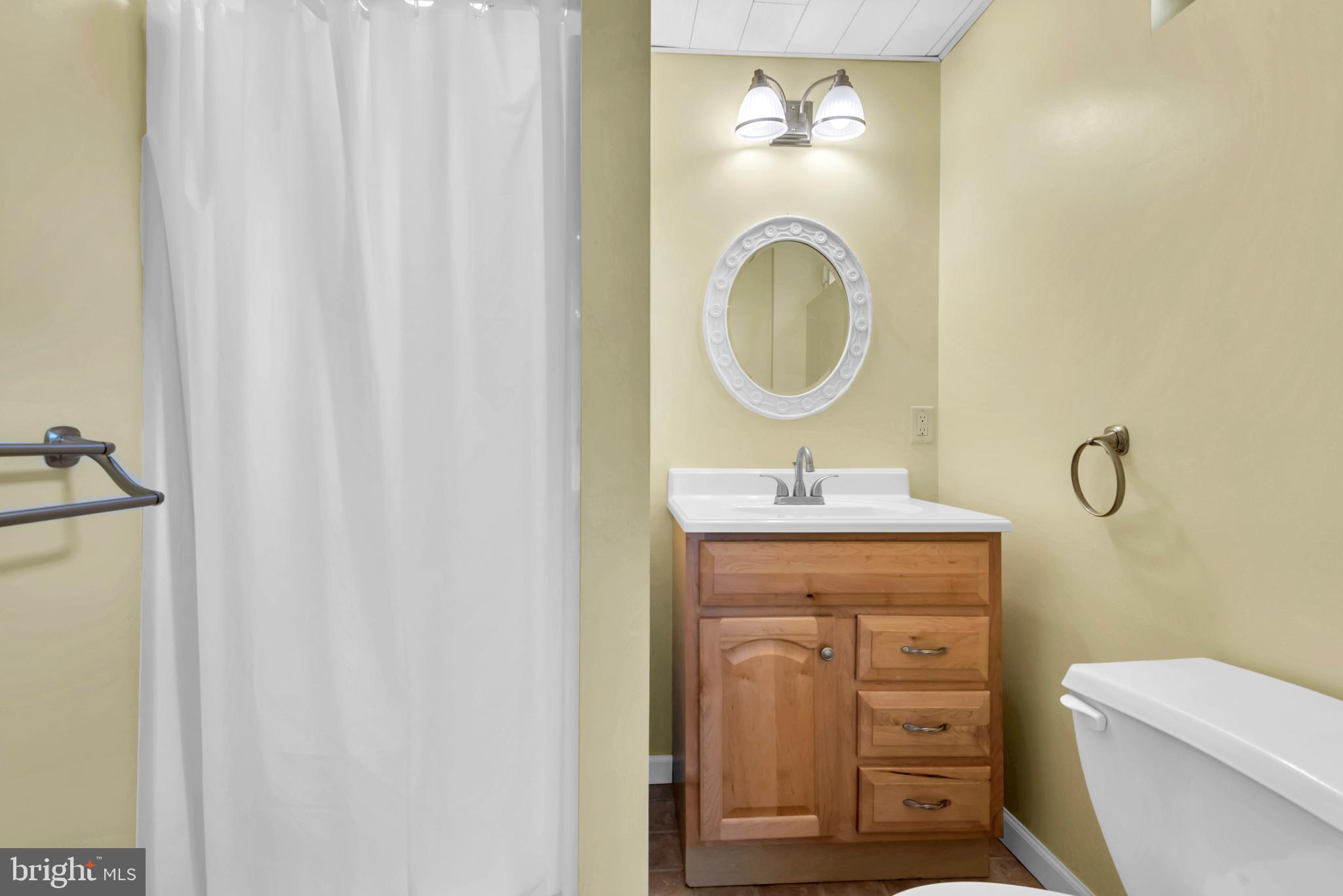 644 Jasontown Road Westminster, MD 21158 - Photo 23 of 36 a bathroom with a granite countertop toilet a sink and a mirror