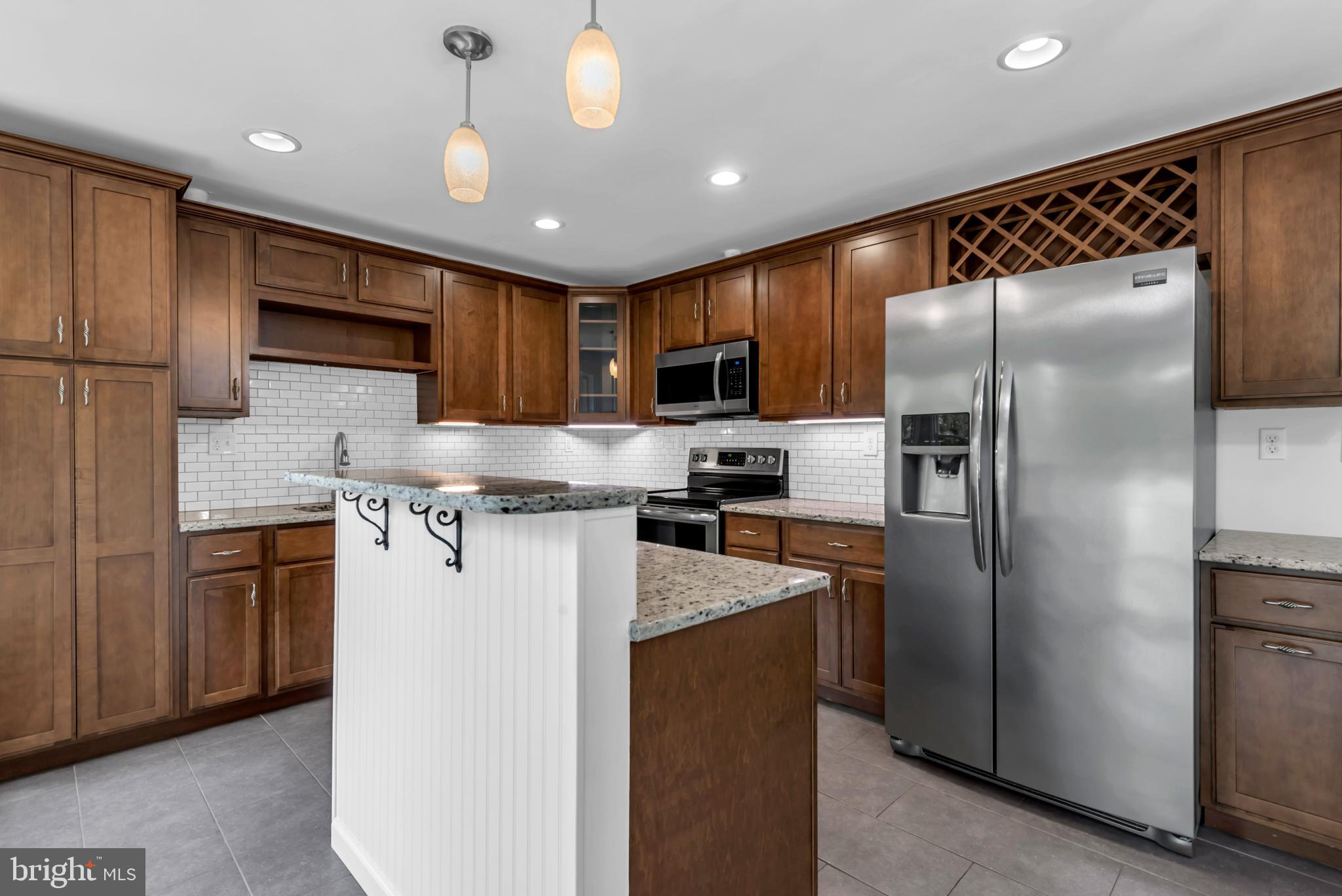 644 Jasontown Road Westminster, MD 21158 - Photo 8 of 36 a kitchen with stainless steel appliances granite countertop a refrigerator a stove a sink and a microwave