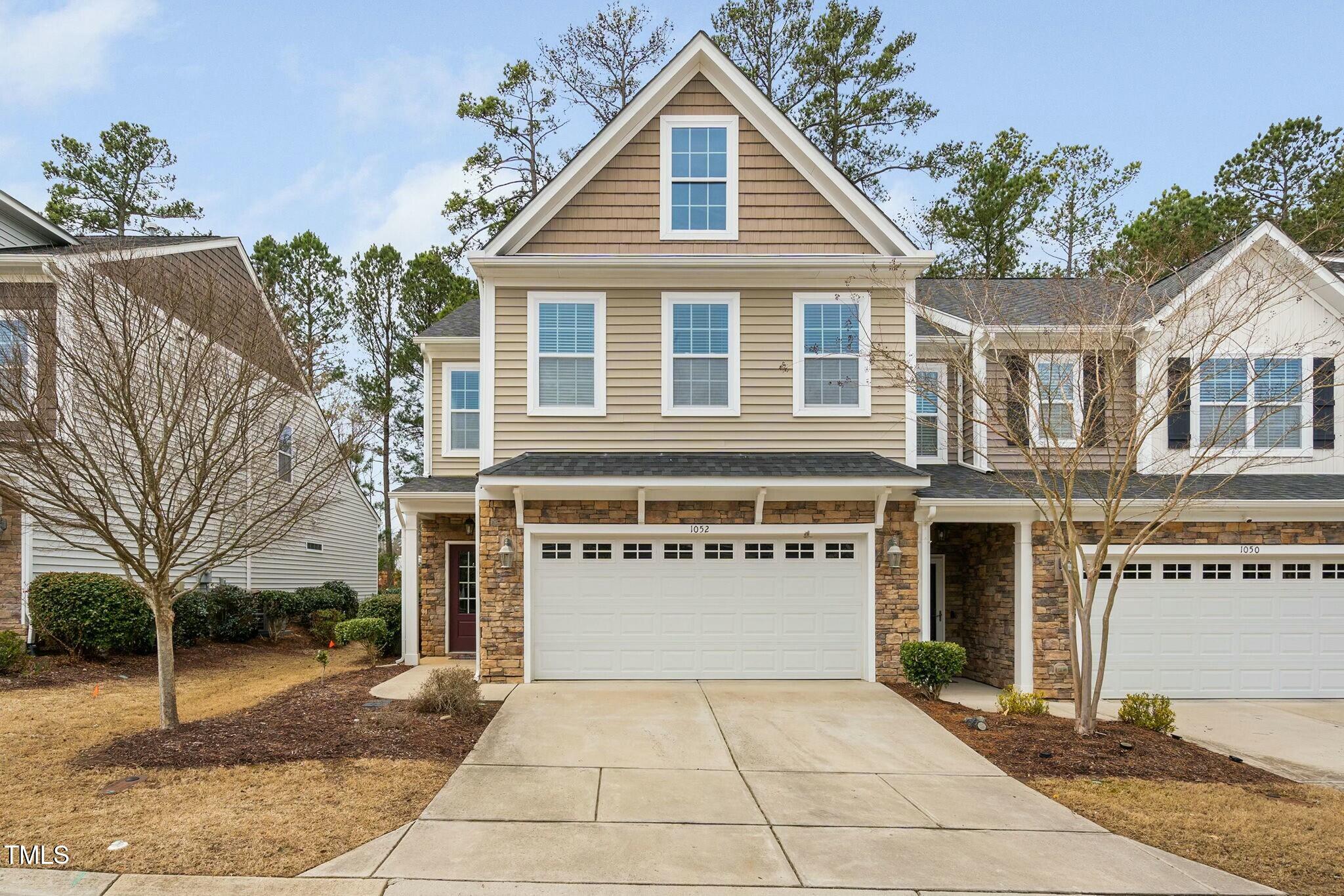 1052 Monmouth Loop Cary, NC 27513 - Photo 1 of 37 a view of a white house with a yard and potted plants