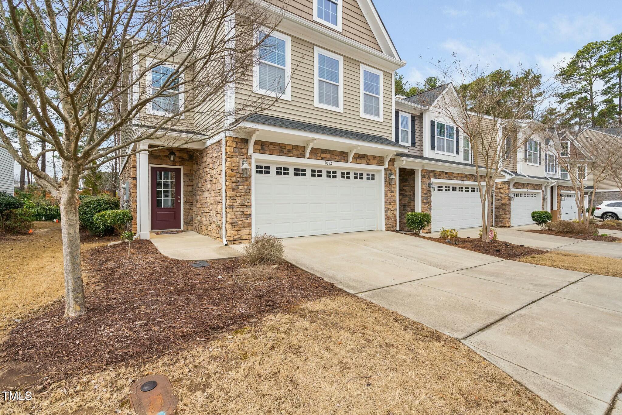 1052 Monmouth Loop Cary, NC 27513 - Photo 2 of 37 a view of a white building among the street with palm trees