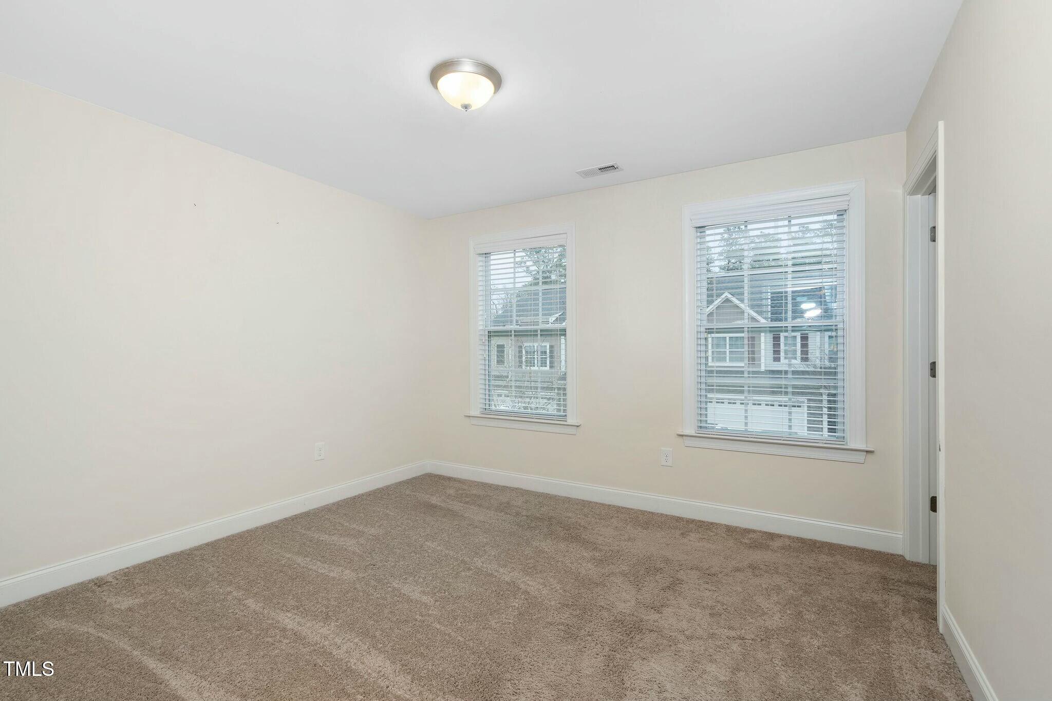 1052 Monmouth Loop Cary, NC 27513 - Photo 27 of 37 an empty room with a window
