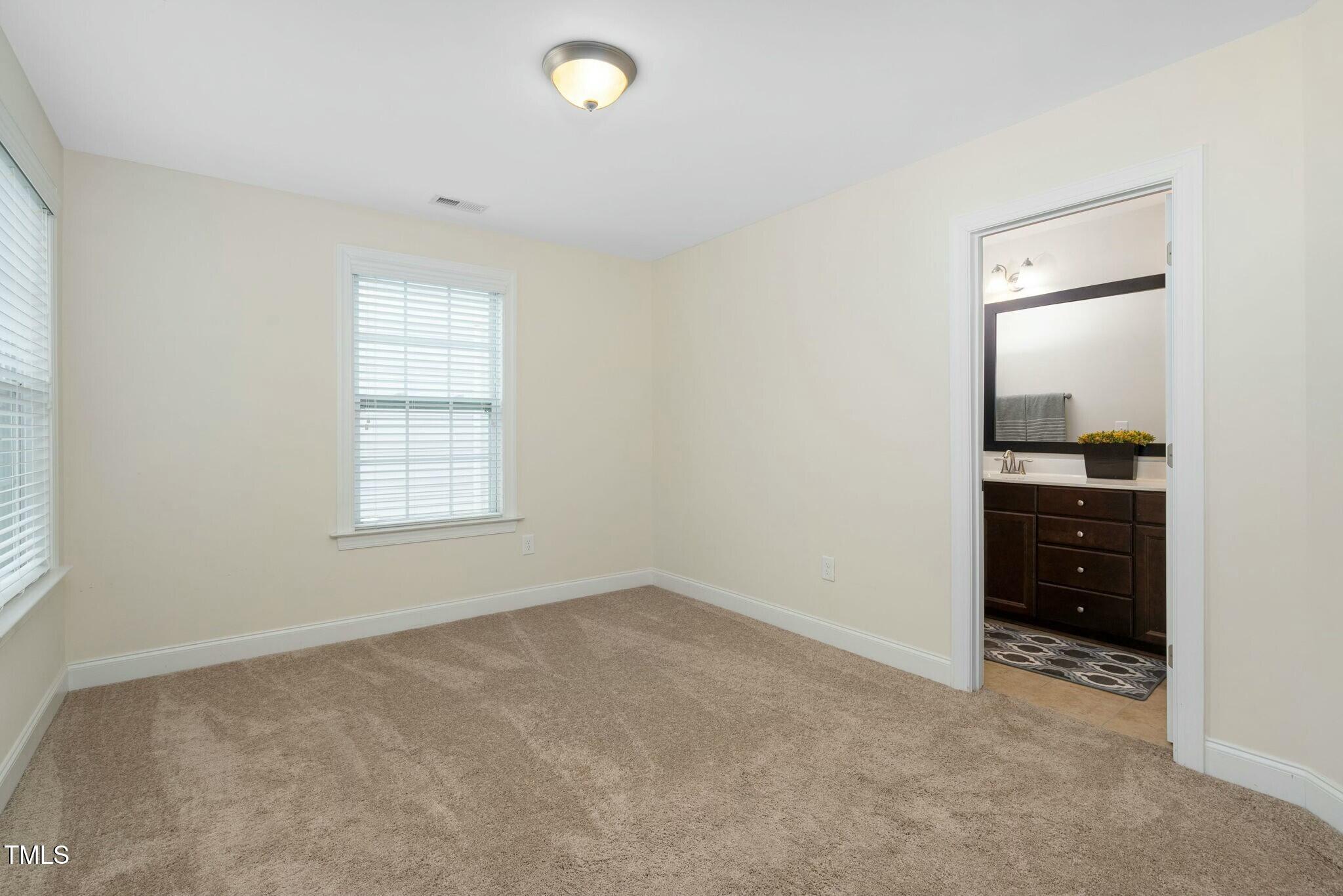 1052 Monmouth Loop Cary, NC 27513 - Photo 29 of 37 an empty room with windows and closet