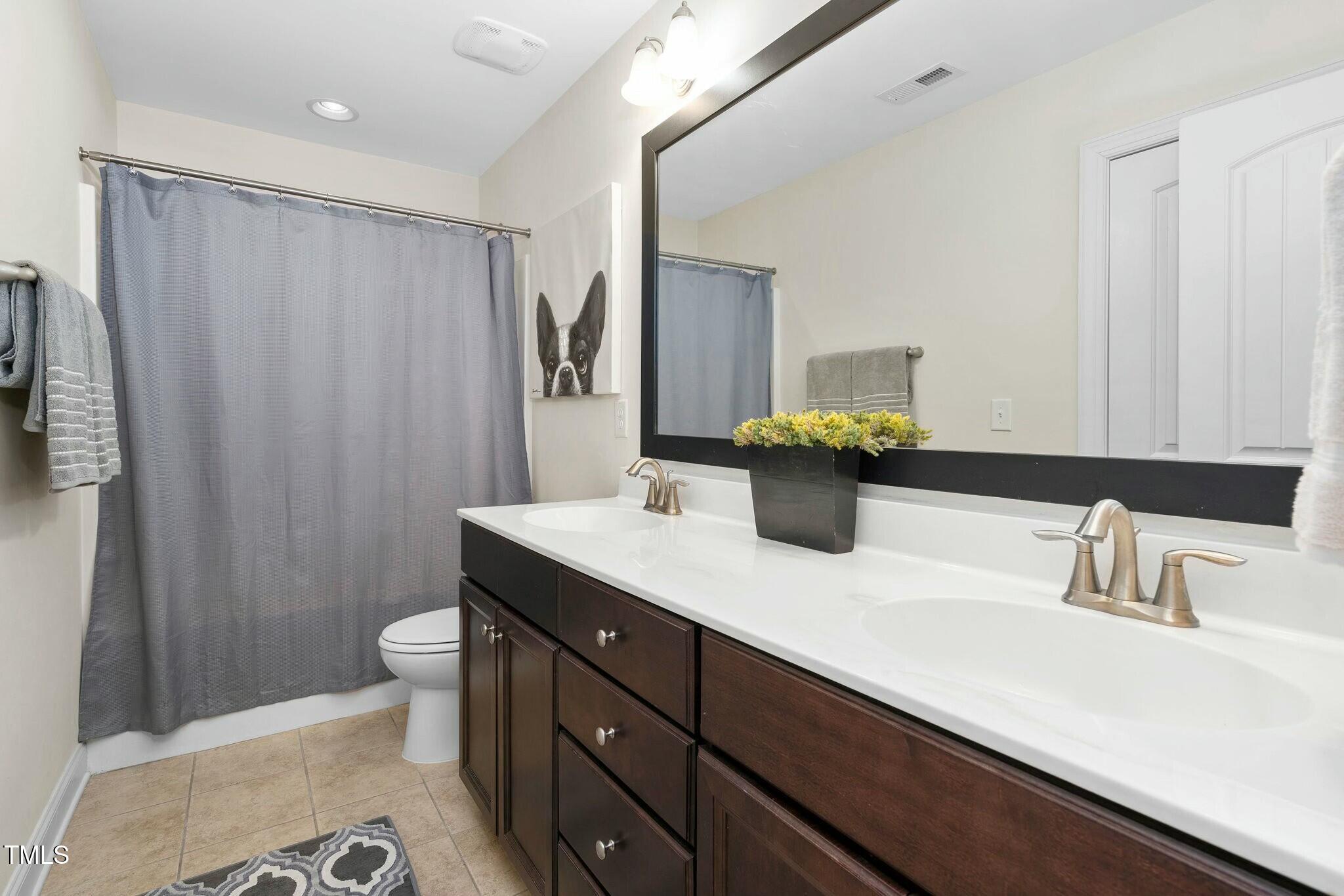 1052 Monmouth Loop Cary, NC 27513 - Photo 31 of 37 a bathroom with a sink a toilet and shower