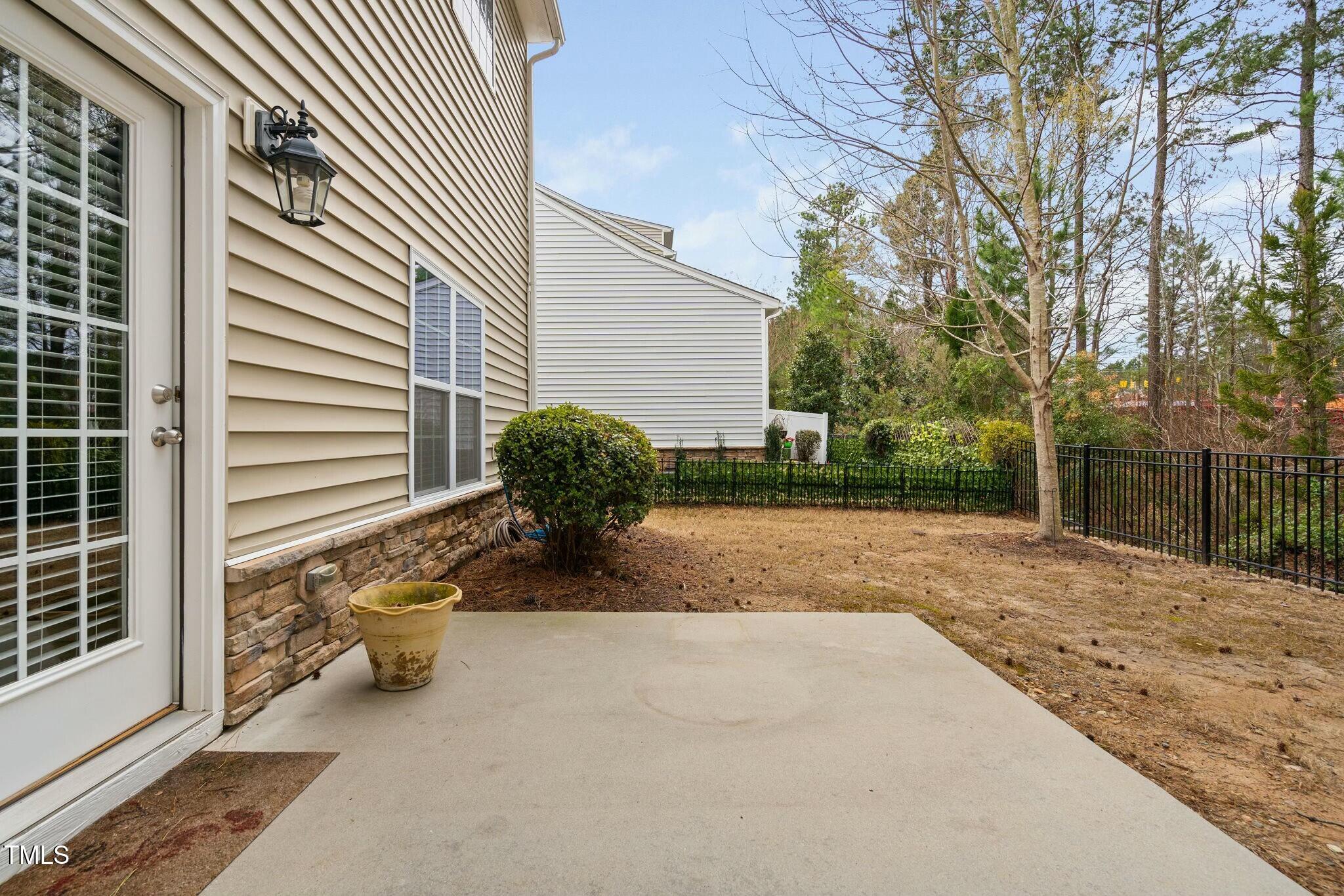1052 Monmouth Loop Cary, NC 27513 - Photo 35 of 37 a view of a backyard with plants and a tree
