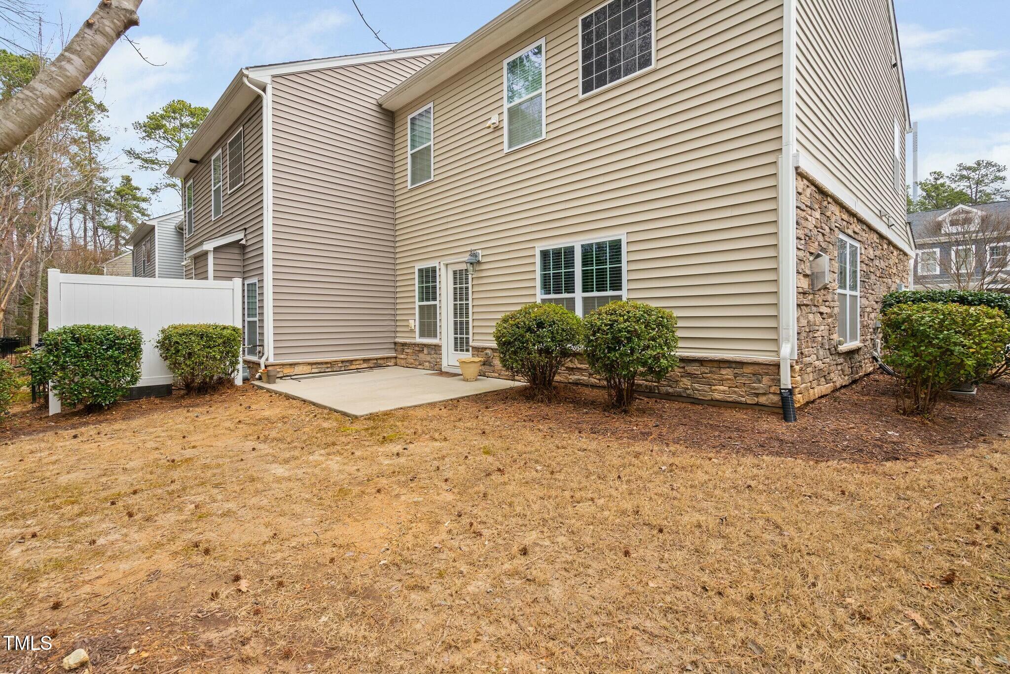 1052 Monmouth Loop Cary, NC 27513 - Photo 36 of 37 a view of a house with backyard and plants