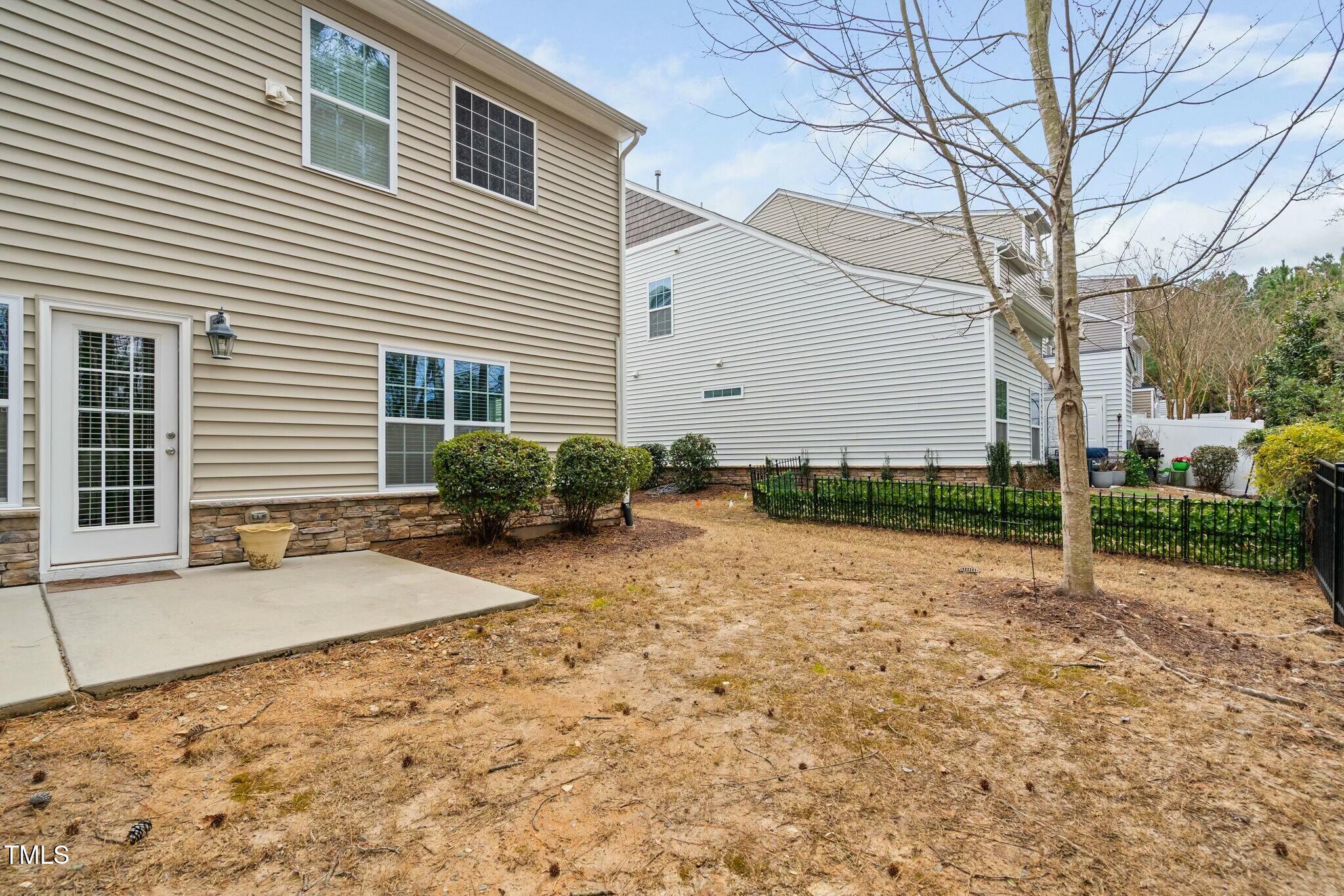 1052 Monmouth Loop Cary, NC 27513 - Photo 37 of 37 a backyard of a house with plants and trees