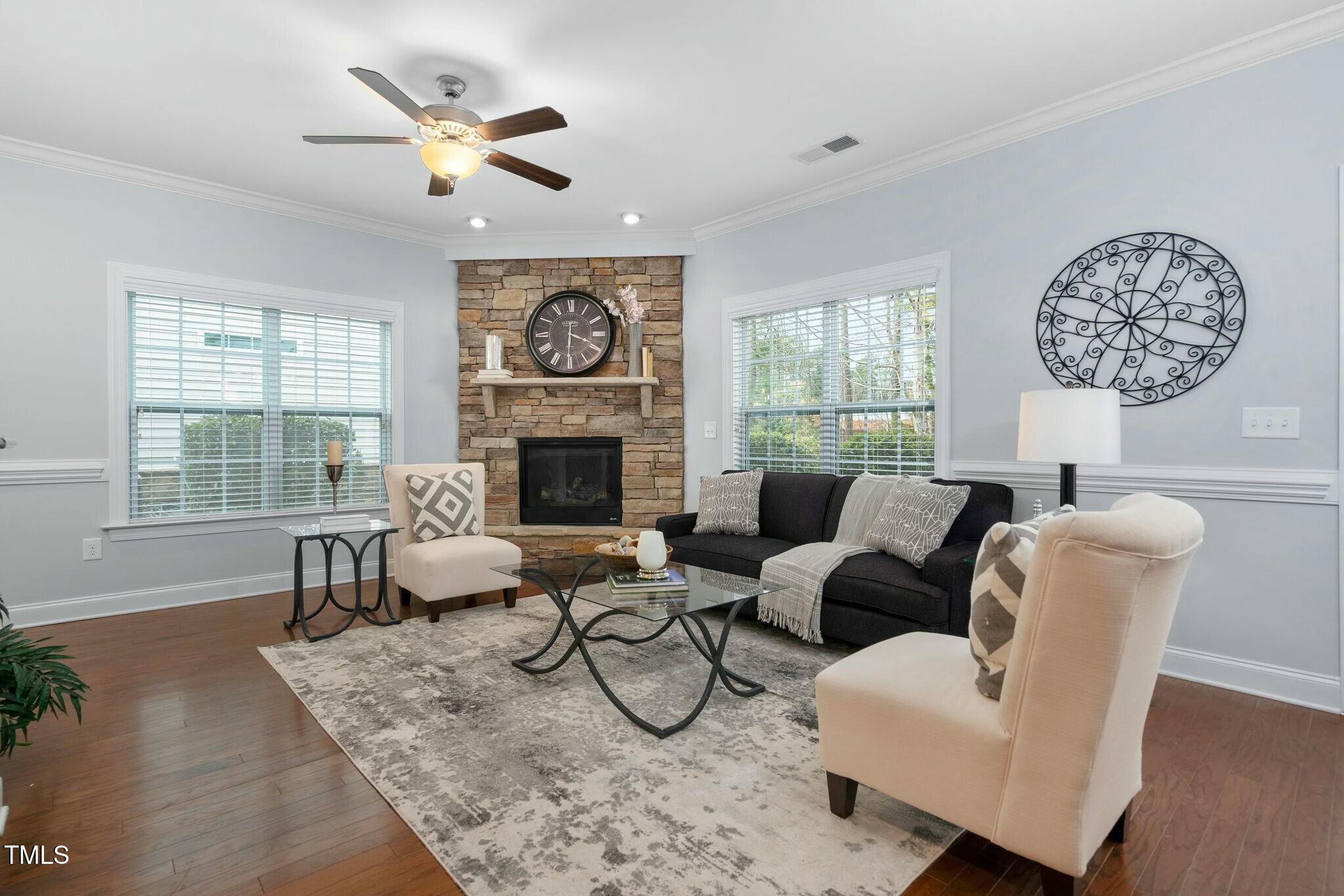 1052 Monmouth Loop Cary, NC 27513 - Photo 5 of 37 a living room with furniture a fireplace and a large window