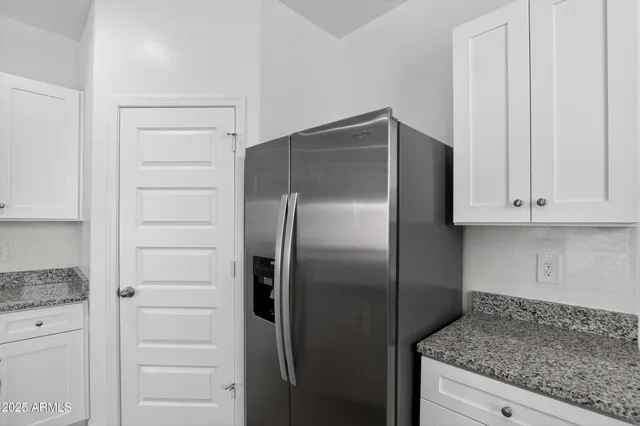a kitchen with a refrigerator and cabinets