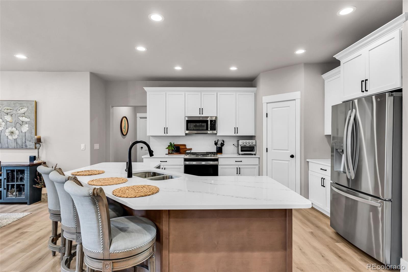 425 Miners Road Canon City, CO 81212 - Photo 12 of 33 a kitchen with refrigerator a stove a sink and chairs