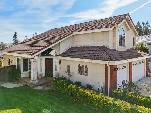a aerial view of a house with a yard and potted plants