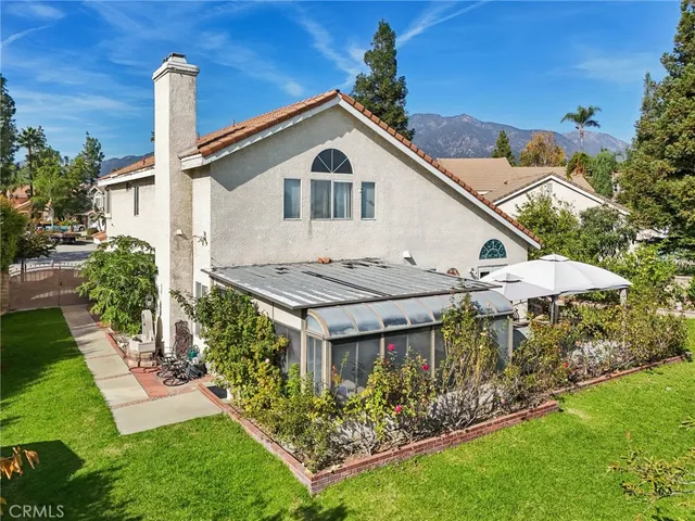 a aerial view of a house with a yard and potted plants