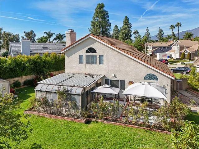 an aerial view of a house with a yard and potted plants