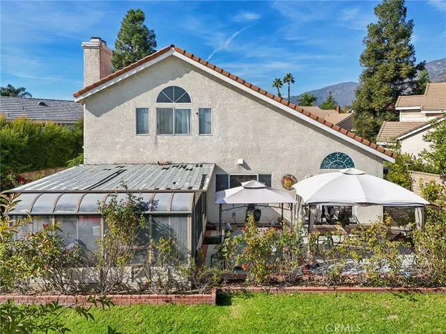 a view of a white house with a yard and sitting area