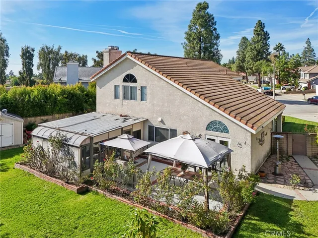 an aerial view of a house with a yard and potted plants