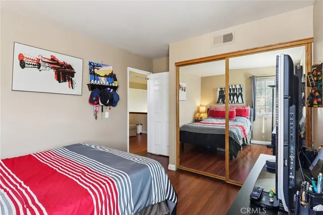 a bedroom with a bed and a mirror