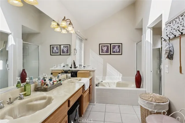 a bathroom with a tub sink mirror and vanity