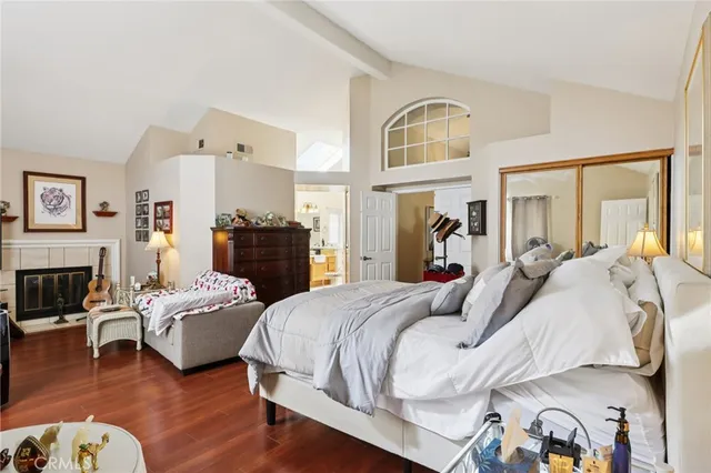 a bedroom with bed and wooden floor