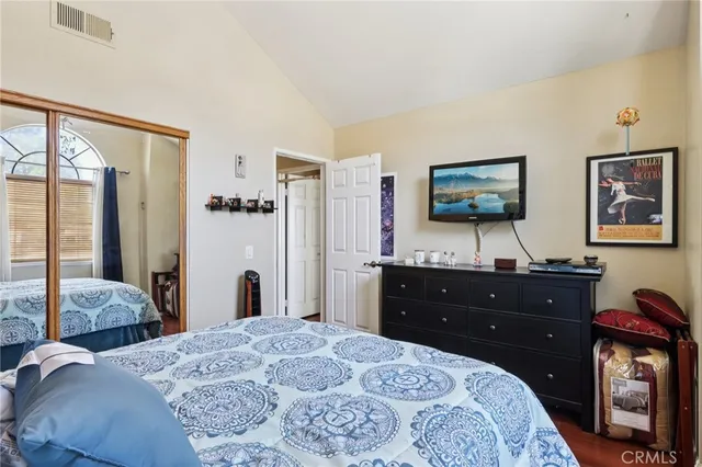 a bedroom with a bed and a flat screen tv