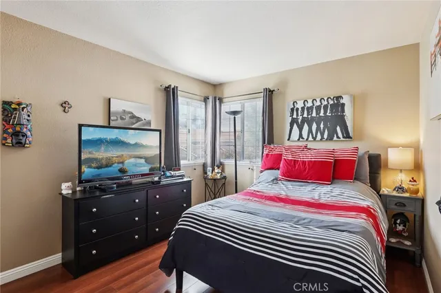 a bedroom with a bed and a flat screen tv