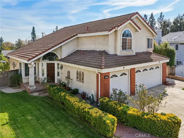 a front view of house with a garden and pathway