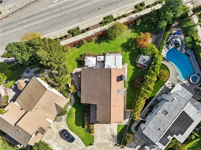 an aerial view of a house with a yard and potted plants