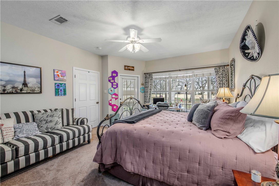 7 Hickory Ridge Lane Hilltop Lakes, TX 77871 - Photo 22 of 37 a bedroom with a bed and a chandelier