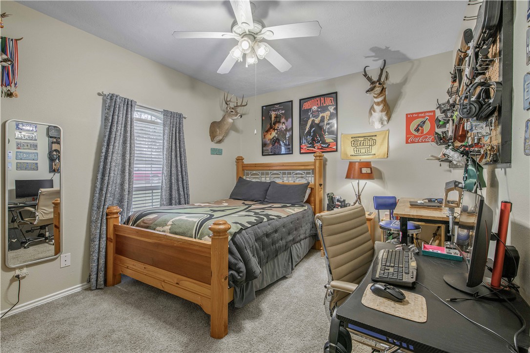 7 Hickory Ridge Lane Hilltop Lakes, TX 77871 - Photo 26 of 37 a bedroom with a bed and a chandelier
