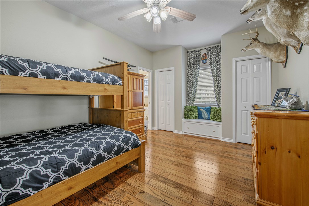 7 Hickory Ridge Lane Hilltop Lakes, TX 77871 - Photo 27 of 37 a bedroom with a bed and a chandelier