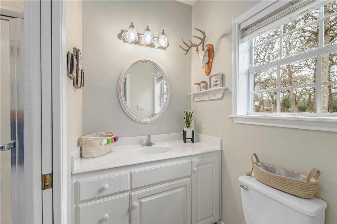 7 Hickory Ridge Lane Hilltop Lakes, TX 77871 - Photo 28 of 37 a bathroom with a toilet sink and mirror