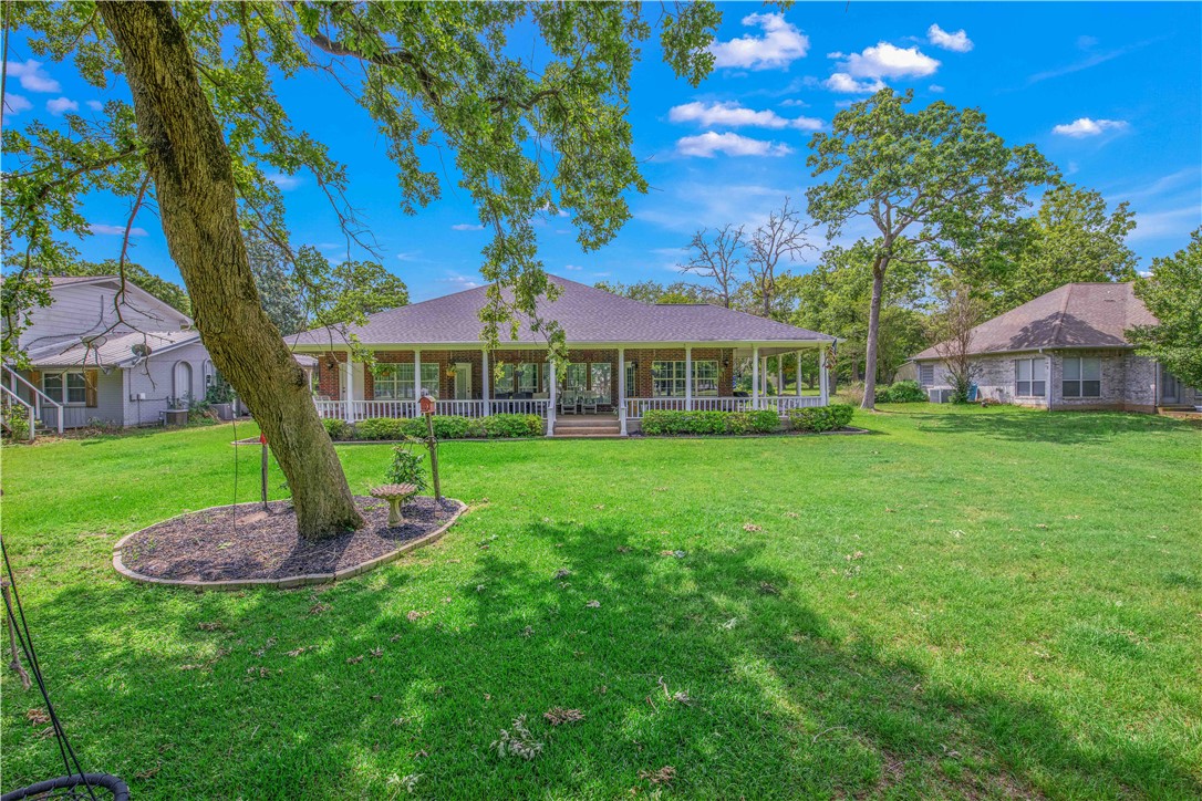 7 Hickory Ridge Lane Hilltop Lakes, TX 77871 - Photo 33 of 37 a front view of a house with garden