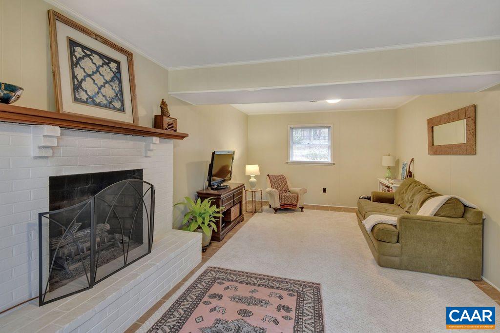 101 Vincennes Road Charlottesville, VA 22911 - Photo 22 of 31 a living room with furniture and a fireplace