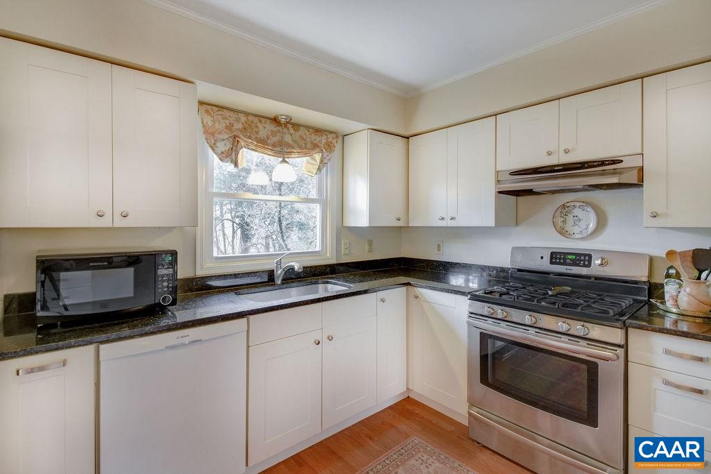 101 Vincennes Road Charlottesville, VA 22911 - Photo 8 of 31 a kitchen with granite countertop white cabinets appliances and a window